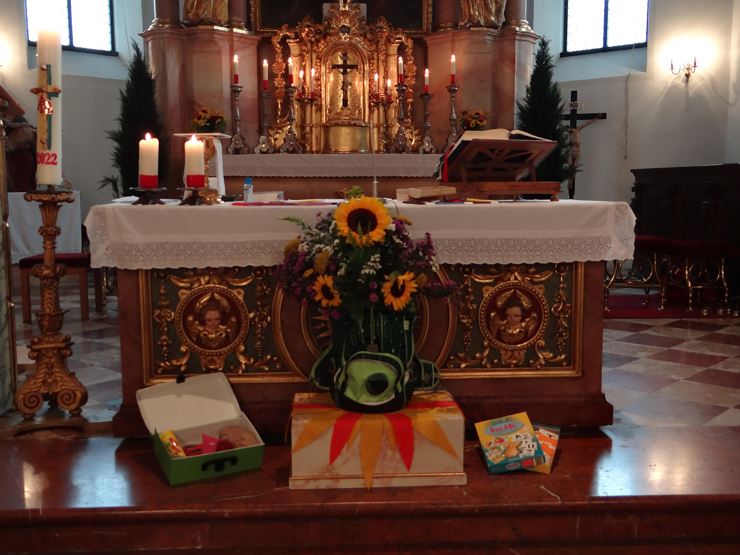 Family service with blessing of kindergarten and school bags